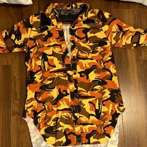 Orange camouflage jacket with black net on shoulder and neck area